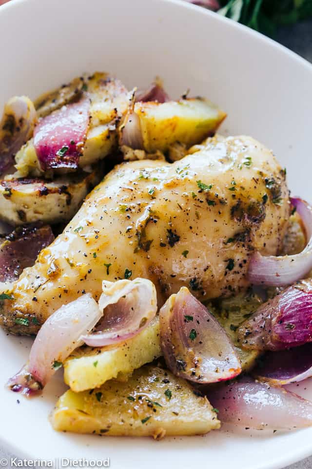 One Pan Roasted Chicken and Potatoes - Quick and easy one pan dinner recipe with chicken coated in a sweet and savory honey mustard sauce and roasted alongside seasoned and incredibly flavorful potatoes and red onions. 