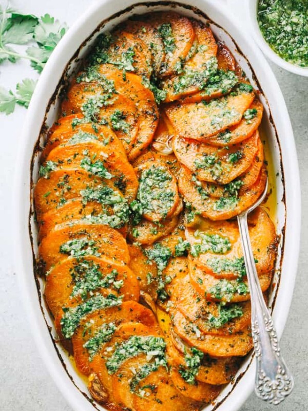 Sweet Potato Roast with Parsley Pesto - Tender, extra-flavorful roasted sweet potatoes with olive oil, a touch of butter, fragrant berbere spice, and topped with the most delicious parsley pesto.