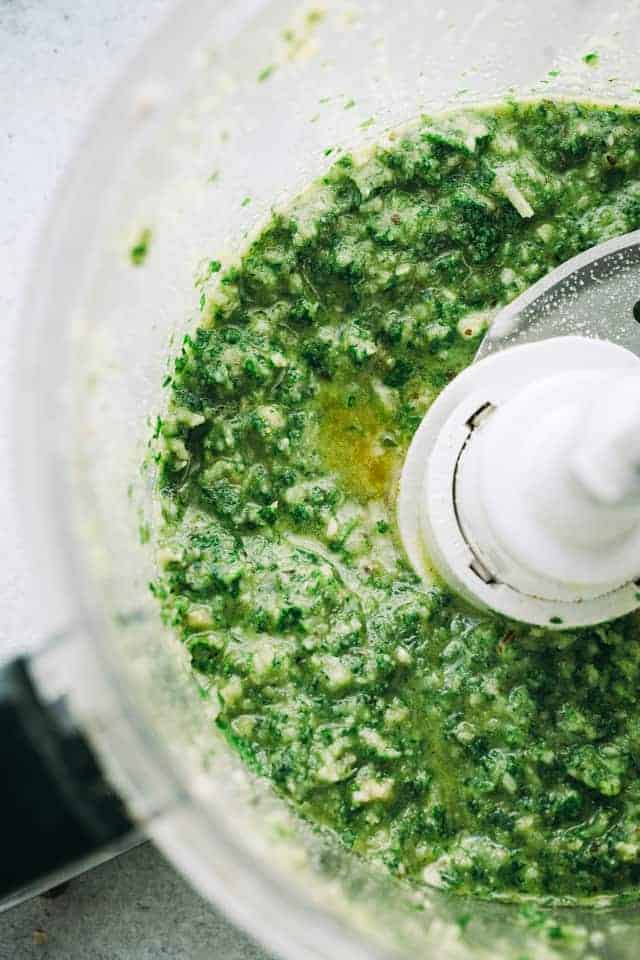 Overhead view of parsley pesto in a food processor
