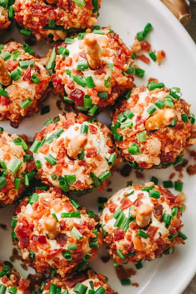 Overhead photo of mini cheese balls rolled in bacon and chives. 