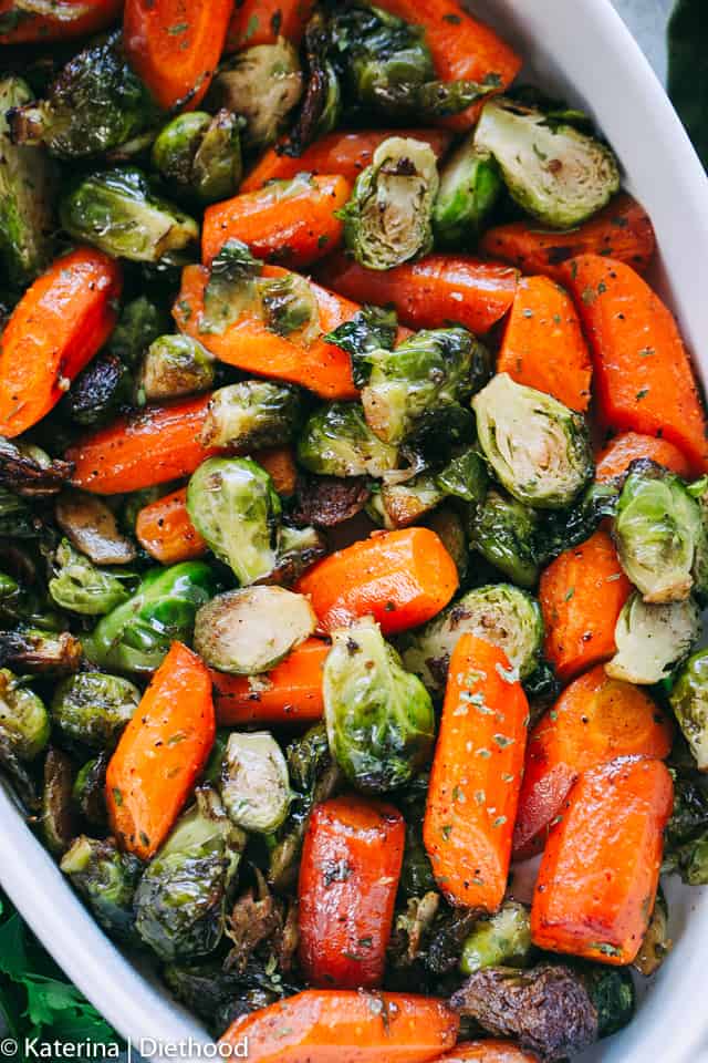 Brussels Sprouts and Carrots in a white oval baking dish.