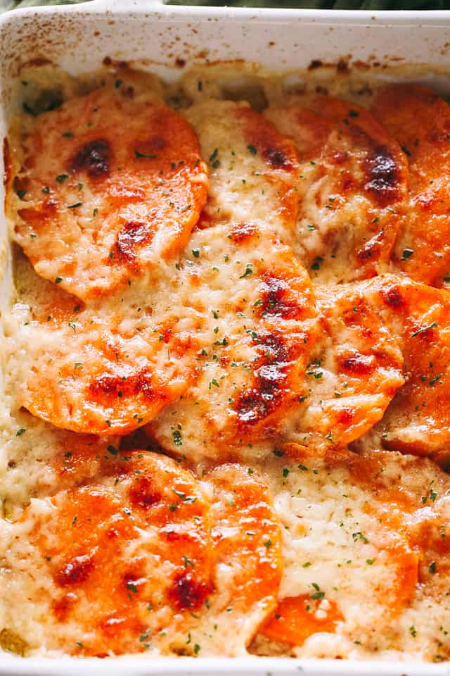 Close-up overhead image of baked Sweet Potato Gratin covered in melty cheese.
