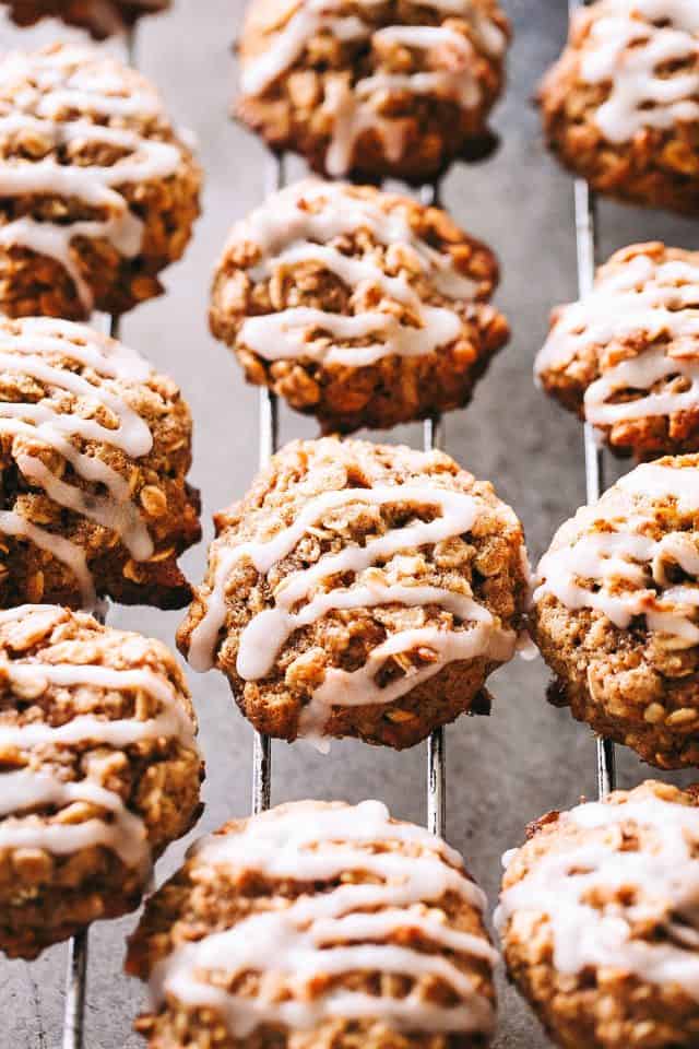 Apple oatmeal cookies drizzled with glaze on a wire rack.