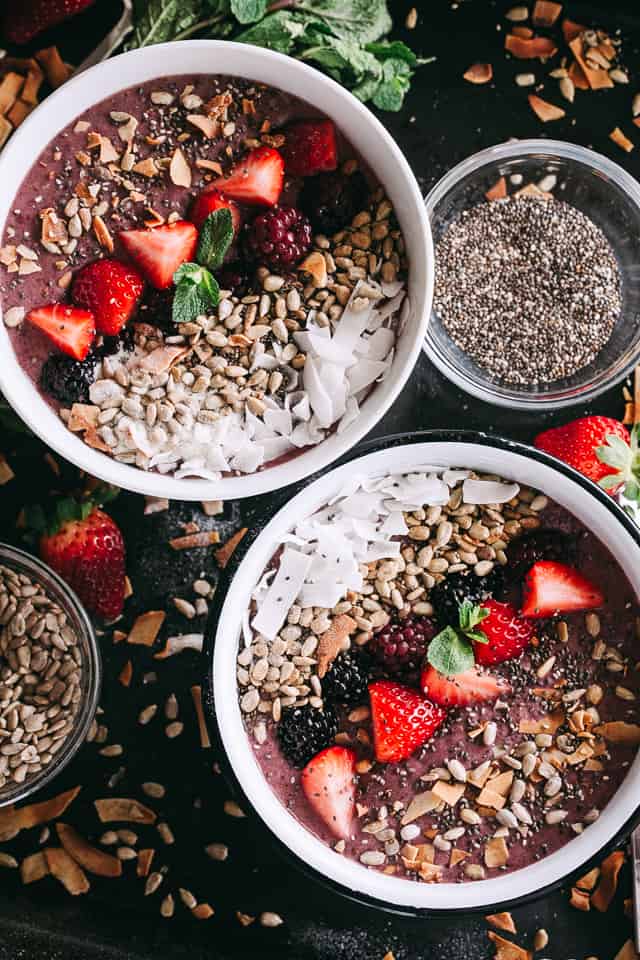 White bowls filled with smoothie and fruits. 