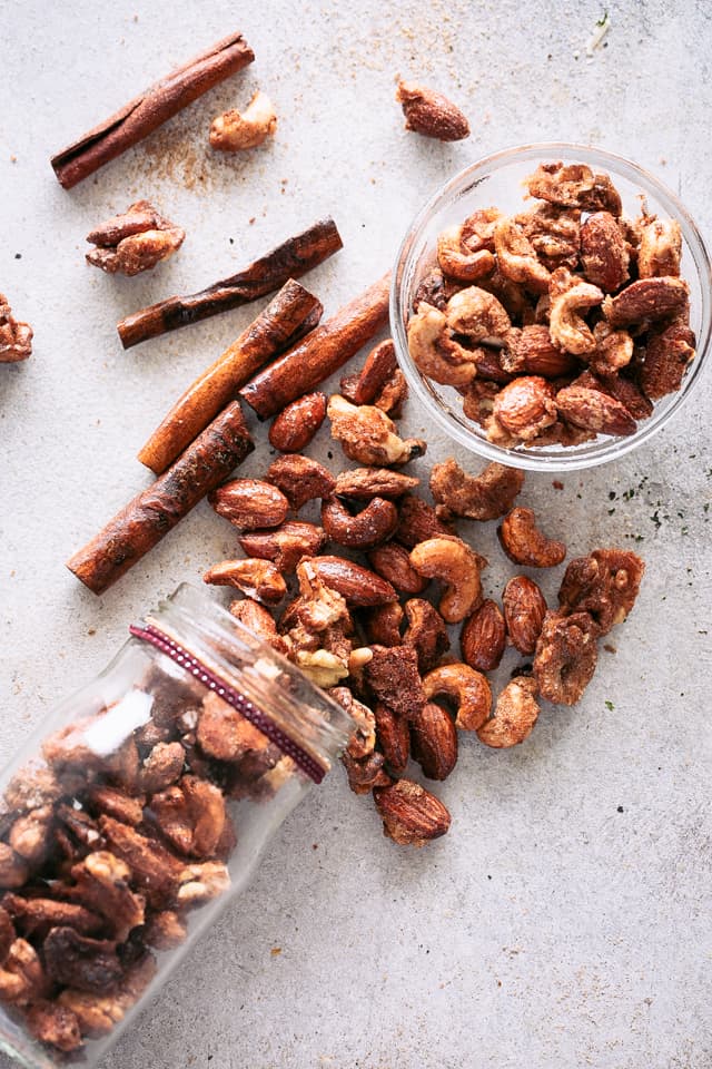 Overhead view of Vanilla Spiced Nuts spilling out of a tipped-over jar and in a bowl