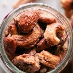 Close up overhead view of spiced nuts in a glass mason jar.