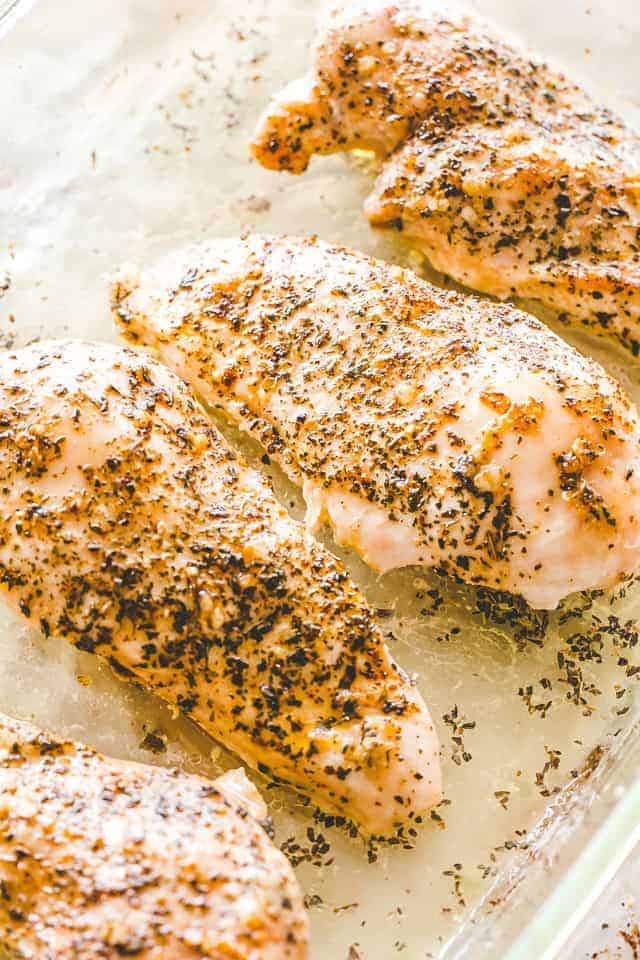 Baked chicken breasts in a baking dish.