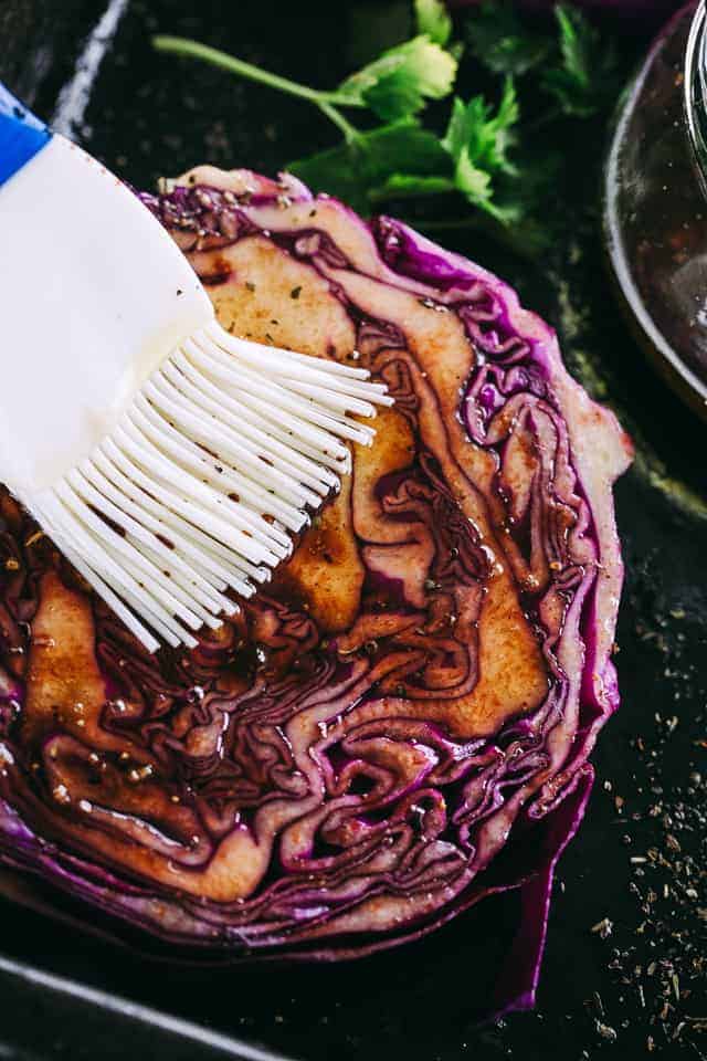 Brushing Cabbage Steaks with balsamic glaze.