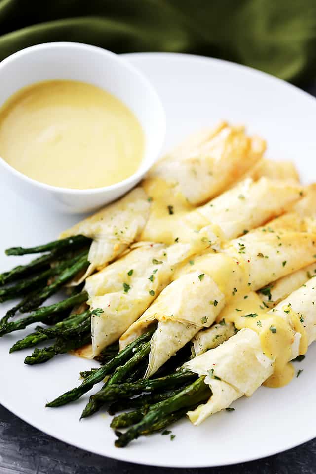 thin asparagus spears wrapped in sheets of phyllo and topped with sauce.