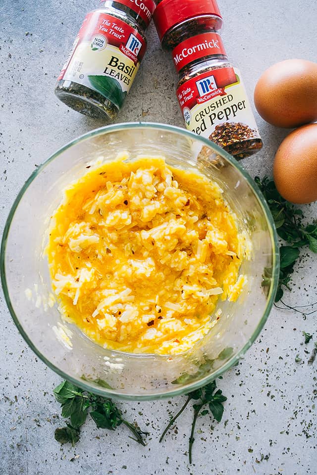 Eggs and cheese sauce in a mixing bowl to be added to zucchini pasta carbonara.