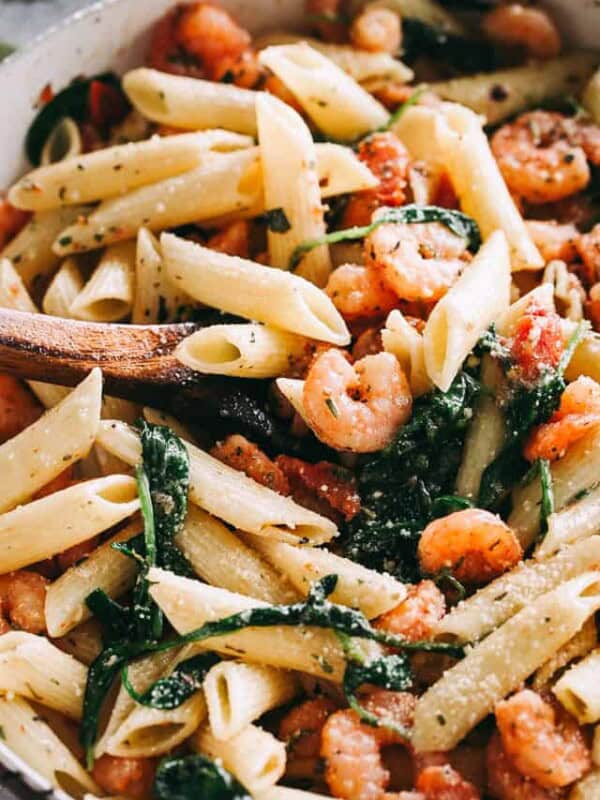 Garlic Butter Shrimp Pasta Recipe - Easy, quick and delicious dinner including shrimp and pasta coated in a light and flavorful garlic butter sauce with tomatoes and spinach.