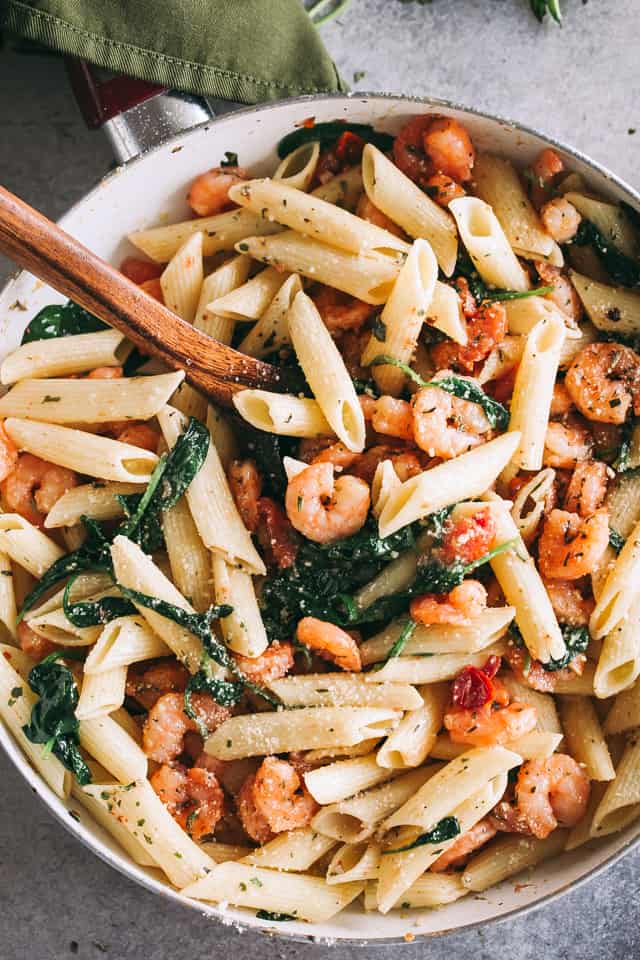 Garlic Butter Shrimp Pasta Recipe - Easy, quick and delicious dinner including shrimp and pasta coated in a light and flavorful garlic butter sauce with tomatoes and spinach.