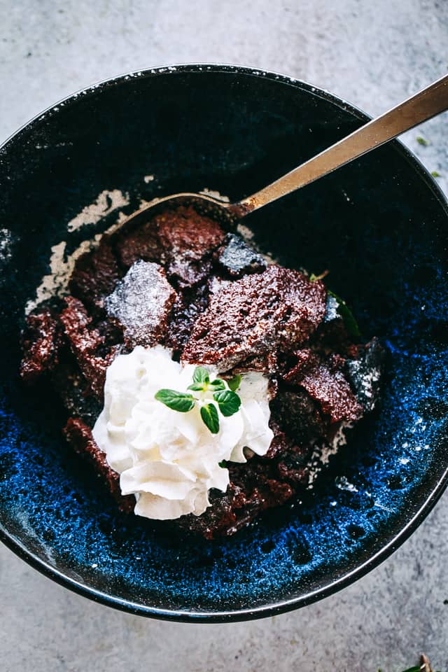 Keto chocolate cake in a bowl with whipped cream