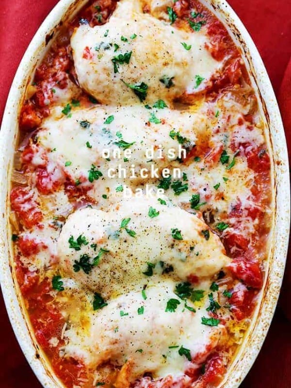 Overhead image of four chicken breasts nestled in tomato sauce and topped with melty cheese.