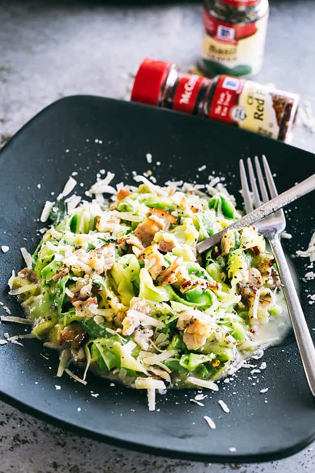 Pasta Carbonara with Zucchini Noodles served on a dinner plate.