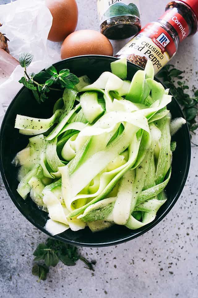 Raw zucchini noodles in a bowl.