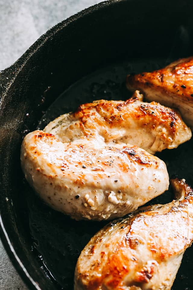 Close up of seared chicken in a skillet.