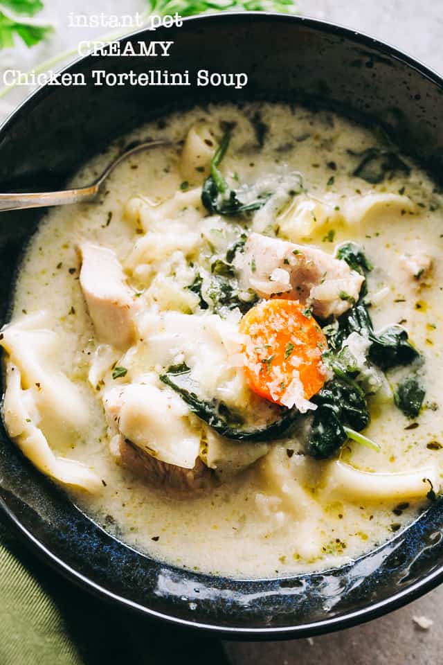Instant Pot Creamy Chicken Tortellini Soup served in a black soup bowl with a spoon