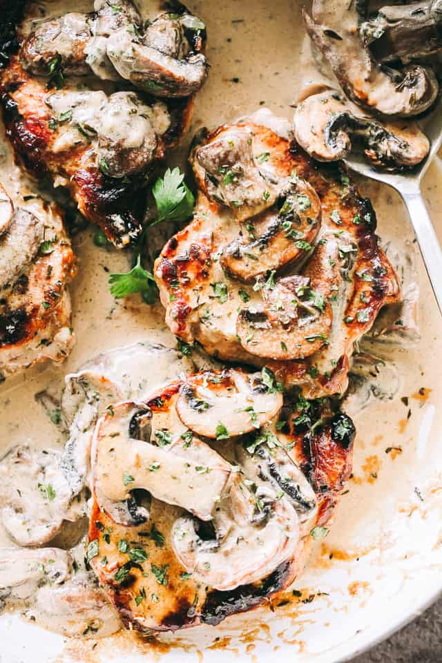 Skillet Pork Chops in Creamy Mushroom Sauce Recipe - Juicy, pan seared pork chops smothered with a rich and creamy mushroom sauce. 