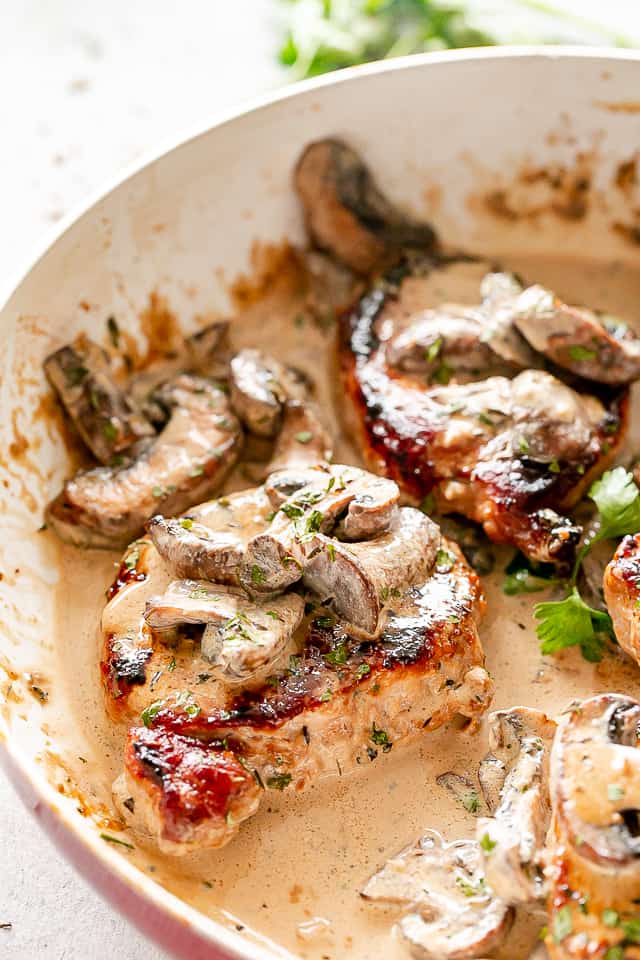 Pork and mushrooms in a skillet.