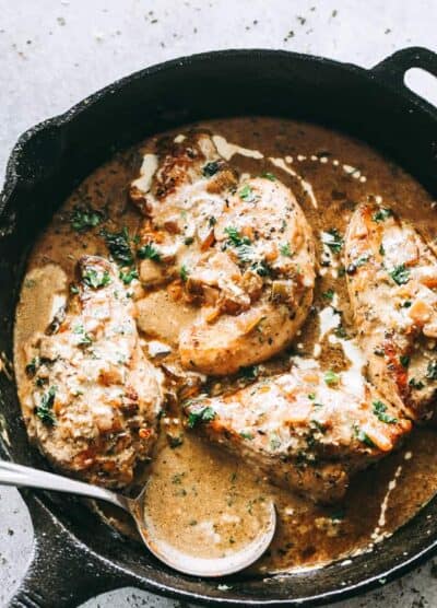 Skillet Chicken in White Wine Sauce - Quick and easy skillet seared chicken topped with a delicious garlic and onions white wine sauce that's sure to please any crowd!