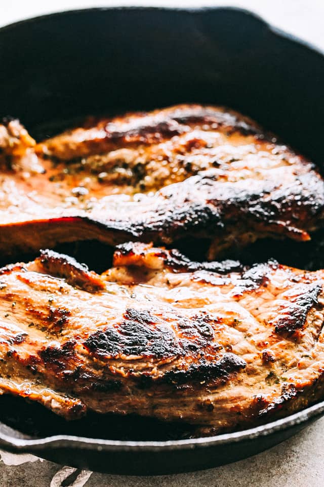 This steak salad recipe is brimming with juicy seared steak, vibrant veggies, and a tangy balsamic dressing that doubles as a steak marinade. Juicy pan-seared steak in a skillet.