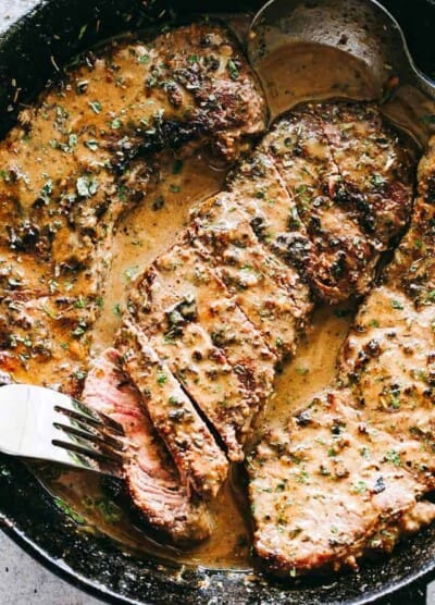 Skillet Bourbon Steak Recipe - Pan seared juicy sirloin steaks prepared with a dijon mustard rub and an incredible creamy bourbon sauce. A one pan recipe that is SO simple and SO darn delicious!