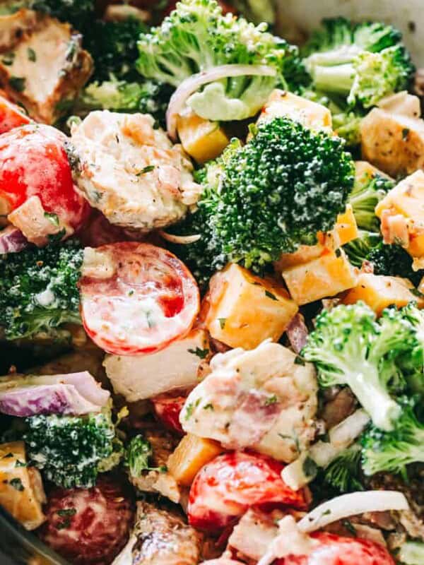 Creamy Broccoli Salad Recipe - Simple, easy, and delicious broccoli salad loaded with cheese, chicken, and bacon tossed with a creamy and flavor packed dressing. It is the perfect side to bring to a picnic or a potluck.