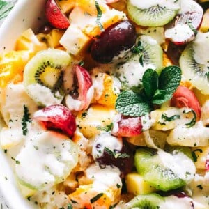 Easy Fruit Salad with Honey Orange Yogurt Dressing Recipe - A fabulous and healthy fruit salad featuring a rainbow of your favorite tropical fruits tossed with a wonderfully sweet and creamy yogurt dressing.