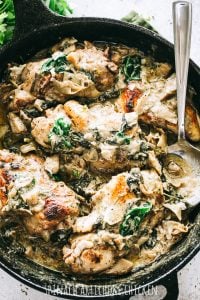 Spinach Artichoke Chicken Recipe - Easy, delicious, and rich skillet dinner prepared with seared chicken breasts, fresh spinach, flavorful artichokes, and an amazing creamy cheese sauce. Quick and easy enough for a weeknight meal, but also great for a special dinner party. 
