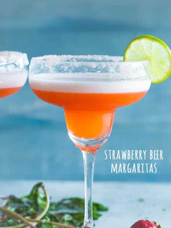 A delicious and pretty twist to the classic Beer Margarita prepared with fresh strawberries, tequila, and beer. The amazing combination of beer and margaritas makes for the perfect cocktail, and if you're looking for an easy party drink, look no further than our Strawberry Beer Margaritas.