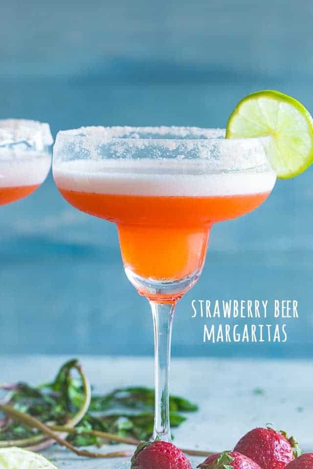 A delicious and pretty twist to the classic Beer Margarita prepared with fresh strawberries, tequila, and beer. The amazing combination of beer and margaritas makes for the perfect cocktail, and if you're looking for an easy party drink, look no further than our Strawberry Beer Margaritas.