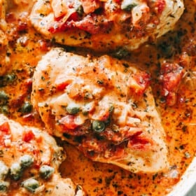 Chicken in Tomato Sauce Recipe - Quick and easy one-skillet dish with pan seared chicken breasts cooked in a flavorful and creamy tomato sauce with capers. It's a perfect midweek meal that takes only 30 minutes to make! 