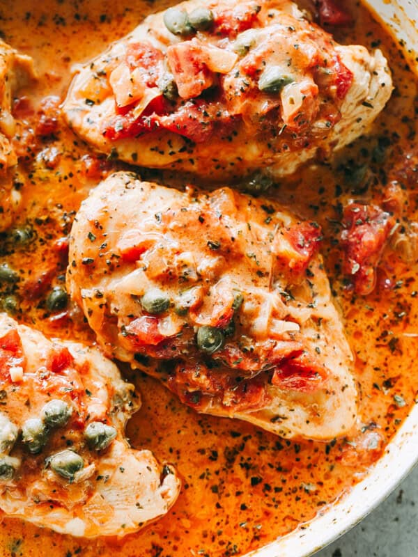Chicken in Tomato Sauce Recipe - Quick and easy one-skillet dish with pan seared chicken breasts cooked in a flavorful and creamy tomato sauce with capers. It's a perfect midweek meal that takes only 30 minutes to make! 