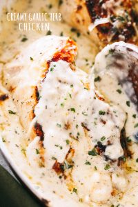 Creamy Garlic Herb Chicken Recipe - Pan-seared chicken breasts prepared with a creamy, garlicky herb sauce. Flavorful, quick weeknight dinner prepared in one pan and in 30 minutes!
