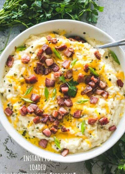 Instant Pot Loaded Mashed Cauliflower - Cheesy, garlicky, flavor loaded mashed cauliflower prepared in the Instant Pot! This is the perfect, most delicious low-carb swap for mashed potatoes!