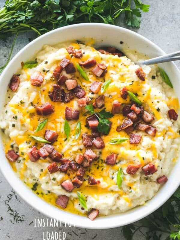 Instant Pot Loaded Mashed Cauliflower - Cheesy, garlicky, flavor loaded mashed cauliflower prepared in the Instant Pot! This is the perfect, most delicious low-carb swap for mashed potatoes!