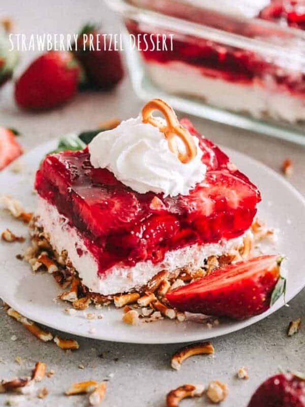 Strawberry Pretzel Dessert square served on a dessert dish and garnished with cream.