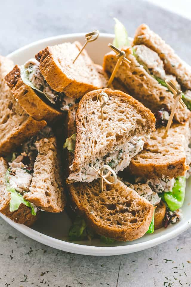Creamy Dill Chicken Salad with Nuts and Cranberries served in small sandwiches.