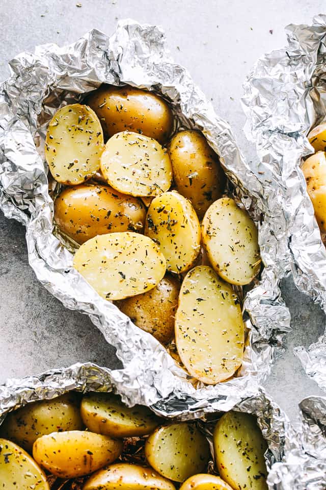 Garlic Herb Grilled Potatoes in Foil - A good dose of garlic, thyme, and rosemary make these potatoes that much more delicious, and the grill gives them just the right amount of crispness and a delicious smoky flavor.