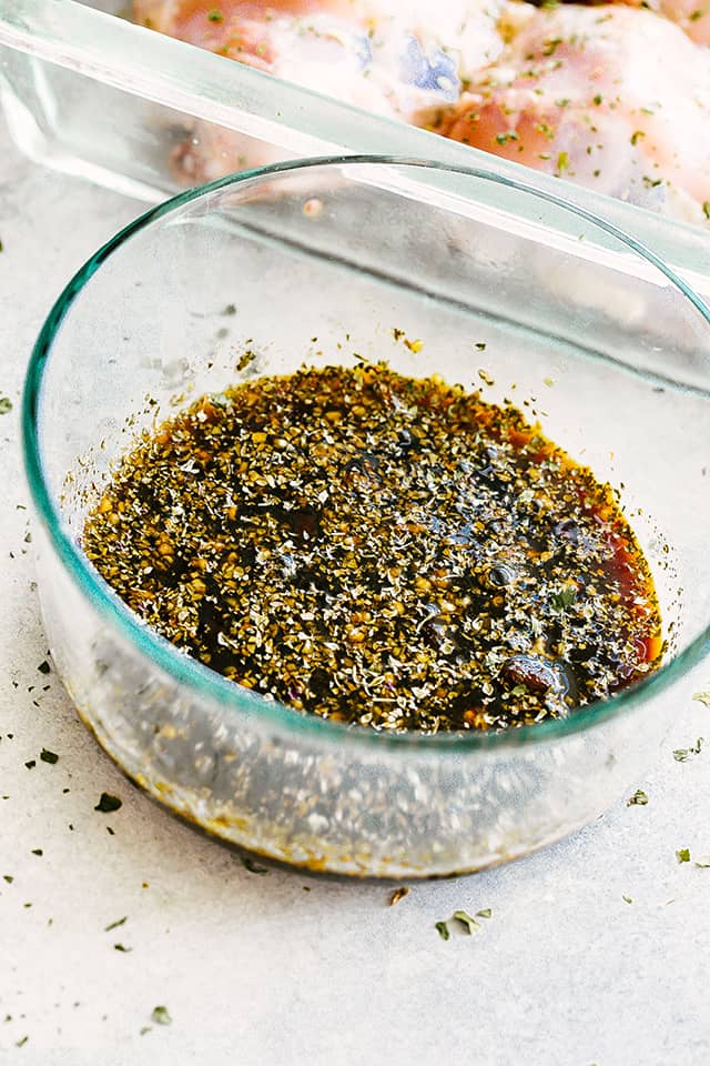 Chicken marinade mixture in a small glass mixing bowl.