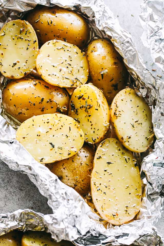 Garlic Herb Grilled Potatoes in Foil - A good dose of garlic, thyme, and rosemary make these potatoes that much more delicious, and the grill gives them just the right amount of crispness and a delicious smoky flavor.