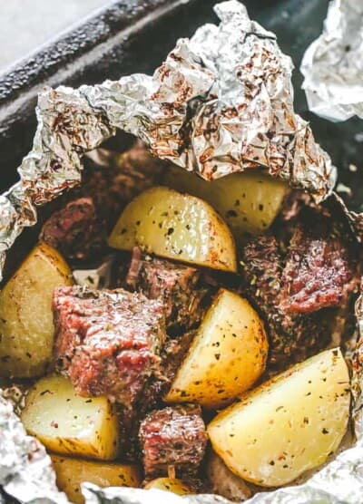 Garlic Herb Steak and Potato Foil Packs - DELICIOUS Steak and potatoes seasoned with garlic and herbs and cooked inside foil packets. They can be cooked on the grill OR in the oven, and are perfect for a family dinner or a backyard get-together. 