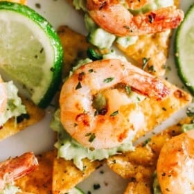 Cajun Shrimp and Guacamole Tortilla Bites - Crispy tortilla chips topped with guacamole and the best tender and juicy cajun shrimp! Super easy and delicious appetizer that's perfect for summer cookouts or game day parties.