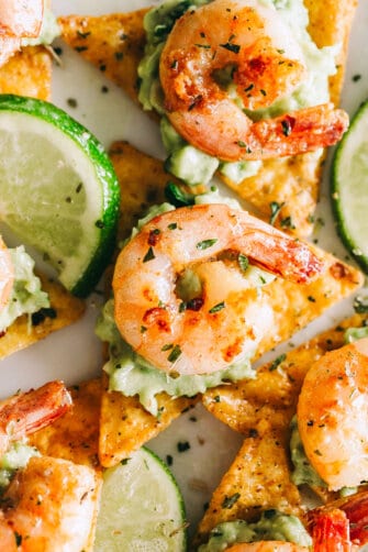 Cajun Shrimp and Guacamole Tortilla Bites - Crispy tortilla chips topped with guacamole and the best tender and juicy cajun shrimp! Super easy and delicious appetizer that's perfect for summer cookouts or game day parties.