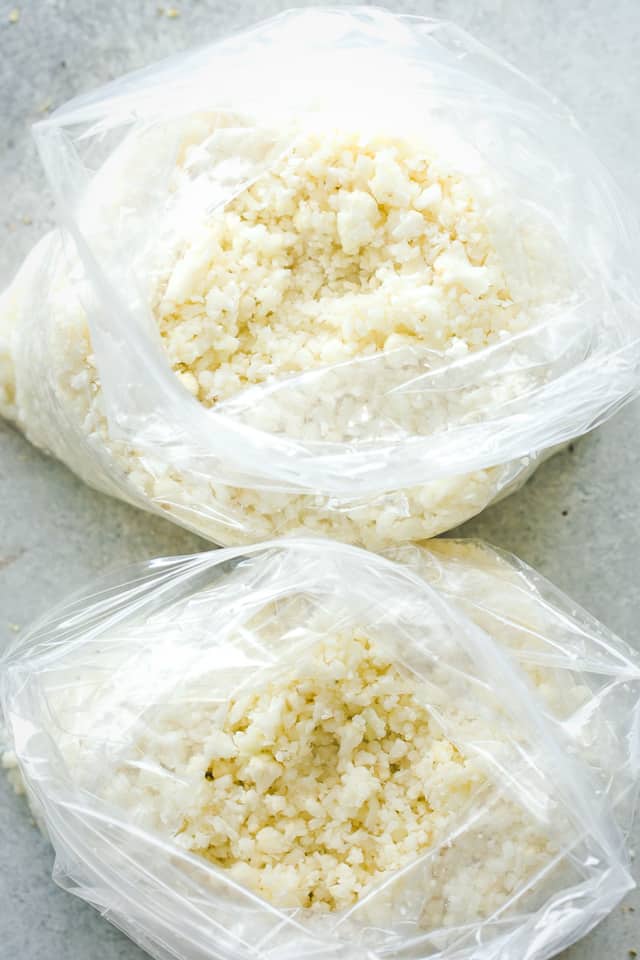 Cauliflower Rice in clear bags, getting them ready for storage.