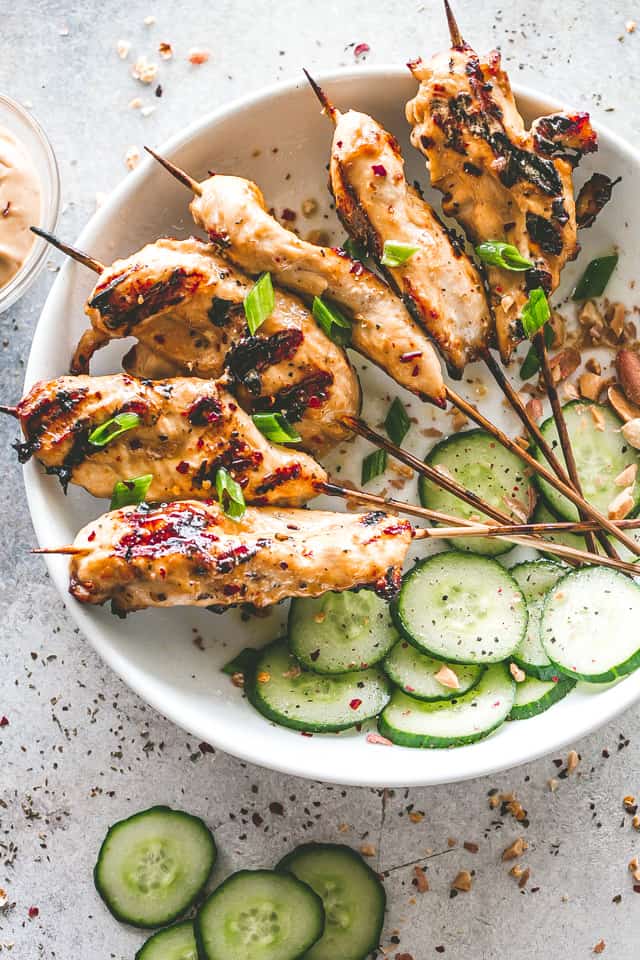 Chicken Satay Skewers with Peanut Sauce - Perfectly spiced grilled chicken skewers soaked in a coconut milk and peanut butter marinade, then grilled and served with a delicious peanut butter dipping sauce.
