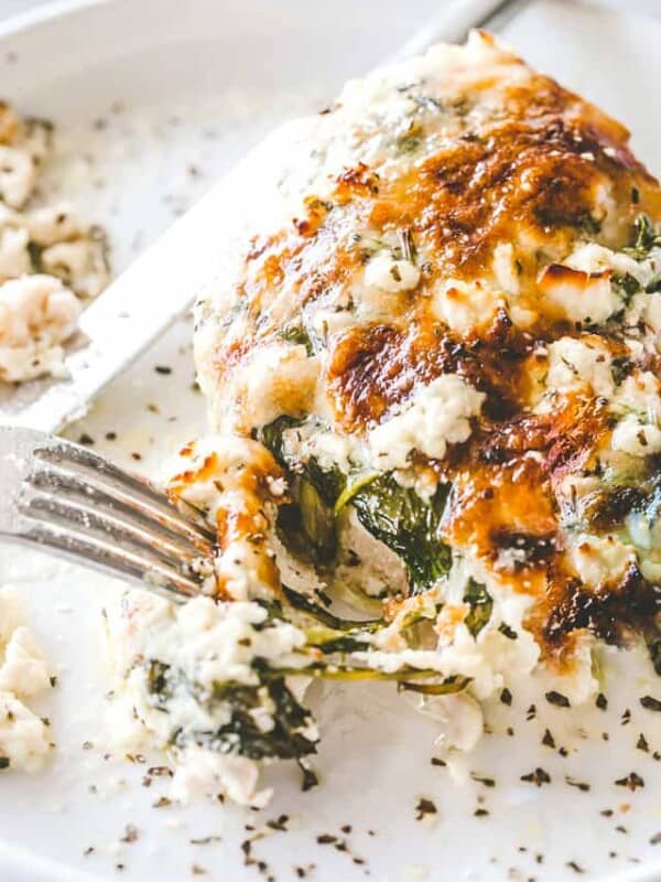 Cheesy Chicken Spinach Bake - Tender baked chicken breasts topped with creamy spinach and melty cheese. A one-pot low carb dinner that's perfect for those busy weeknights!