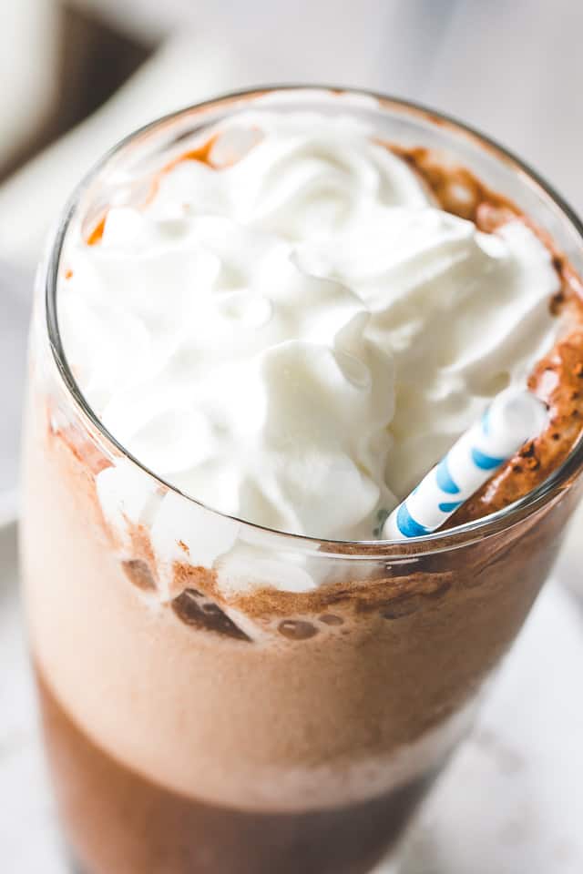 Close-up image of a Frappe topped with whipped cream.