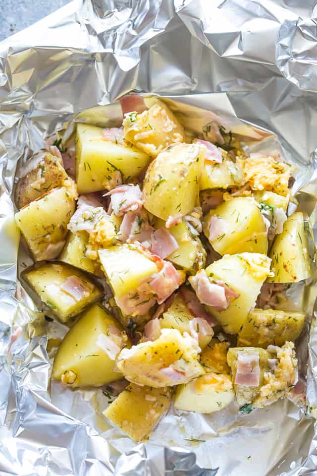 Cheesy Bacon Potato Foil Packets Recipe - Flavor-loaded potatoes and bacon cooked inside foil packs, then topped with melty cheese and green onions. A delicious and easy twist on the classic loaded potatoes!